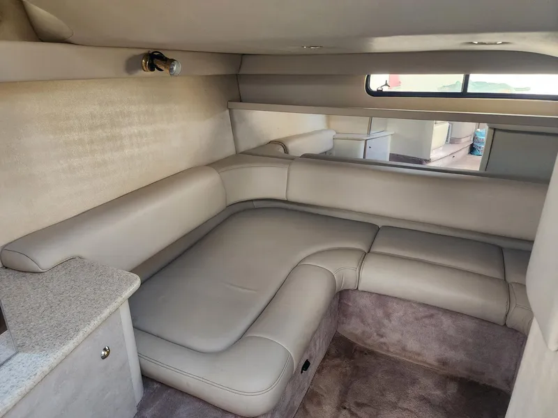 Slide: The Image of 2002 Formula 31 PC cabin interior with beige leather seating and carpeted flooring. - 8