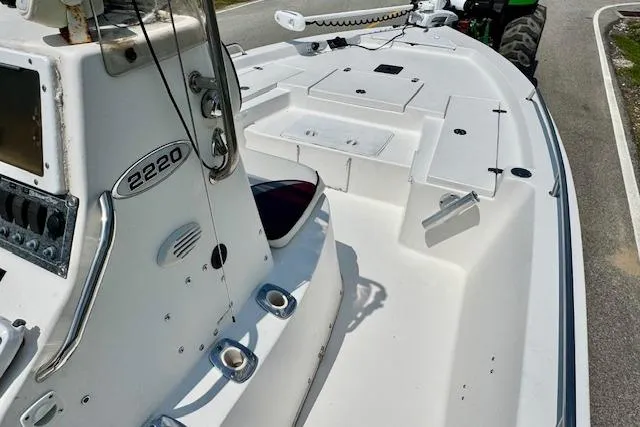 Slide: The Image of 2003 Blazer Bay 2220 Fisherman boat, white deck, console, and storage compartments. - 13