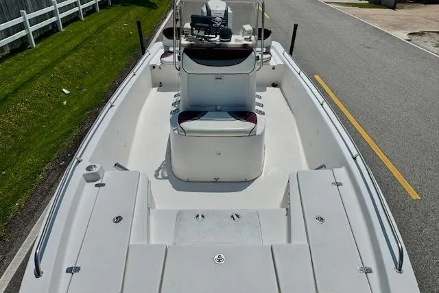 Slide: The Image of 2003 Blazer Bay 2220 Fisherman boat on a road, showcasing spacious deck layout. - 14