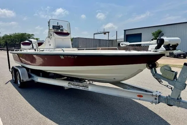 Slide: The Image of 2003 Blazer Bay 2220 Fisherman boat on trailer, parked outdoors under a clear sky. - 5