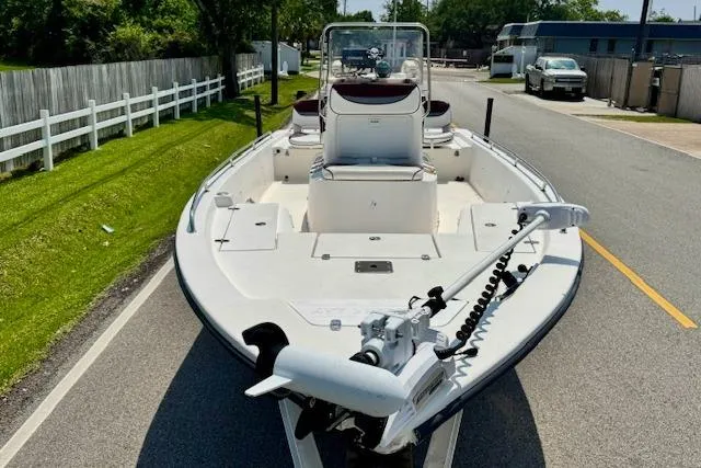 Slide: The Image of 2003 Blazer Bay 2220 Fisherman boat on a road, featuring a trolling motor. - 6