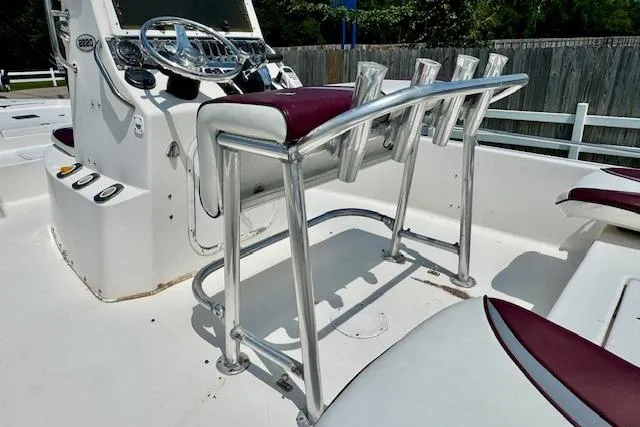 Slide: The Image of 2003 Blazer Bay 2220 Fisherman boat console with rod holders and steering wheel. - 8
