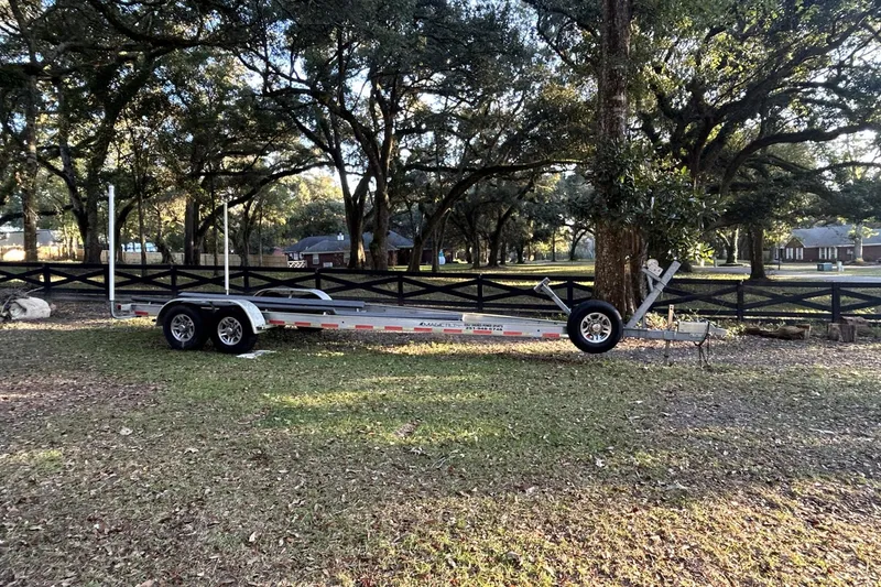Slide: The Image of Trailer for 2022 Sportsman Open 282TE Center Console in a wooded area. - 7