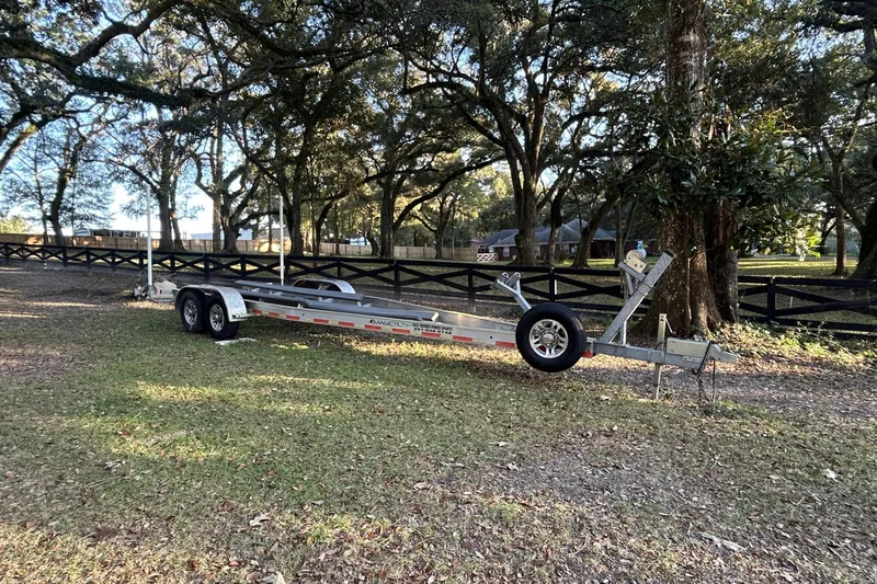 Slide: The Image of Trailer for 2022 Sportsman Open 282TE Center Console in a wooded area. - 8