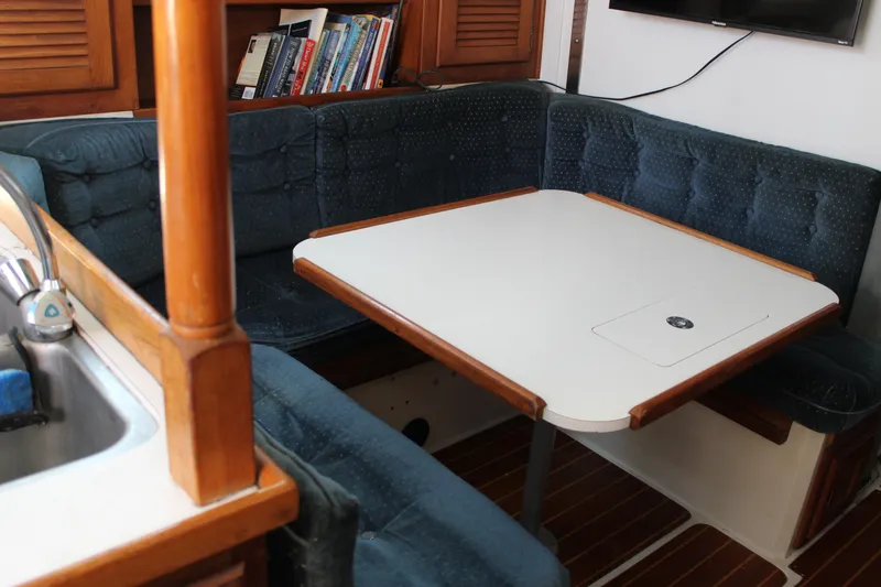 Slide: The Image of Interior of 1991 Catalina 36 MkII sailboat with cozy dining area and bookshelves. - 10