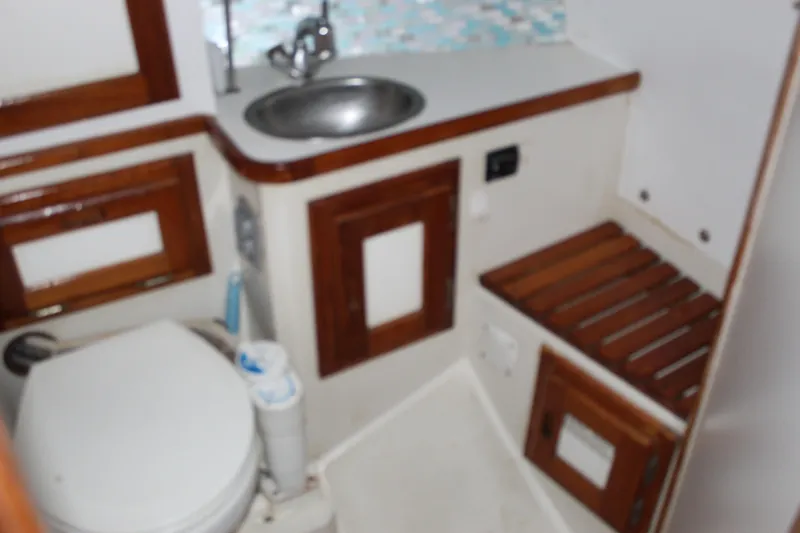 Slide: The Image of Bathroom interior of a 1991 Catalina 36 MkII sailboat with wooden accents. - 11