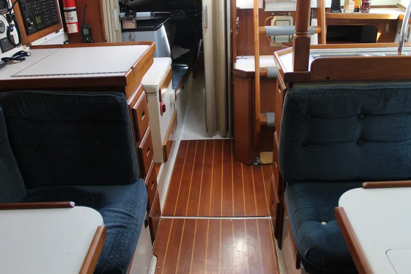Slide: The Image of Interior of a 1991 Catalina 36 MkII sailboat with wooden flooring and seating. - 13
