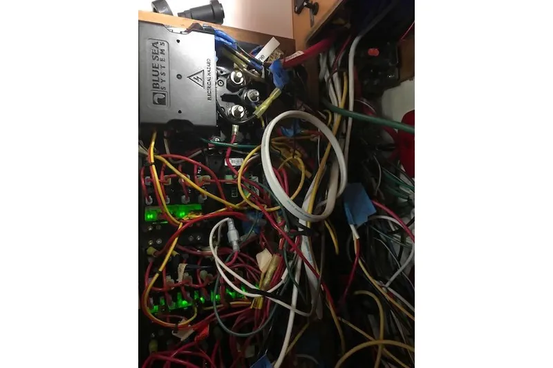 Slide: The Image of Electrical wiring and Blue Sea Systems panel inside a 1991 Catalina 36 MkII sailboat. - 17