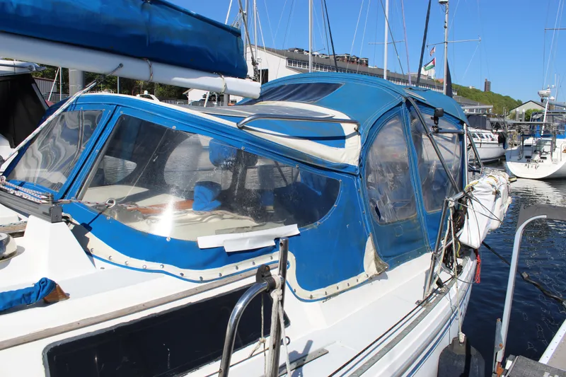 Slide: The Image of 1991 Catalina 36 MkII sailboat with blue canopy docked at marina. - 5