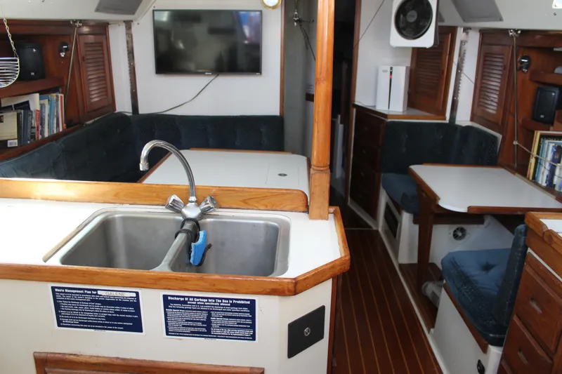 Slide: The Image of Interior of 1991 Catalina 36 MkII sailboat with sink, seating, and wooden accents. - 6