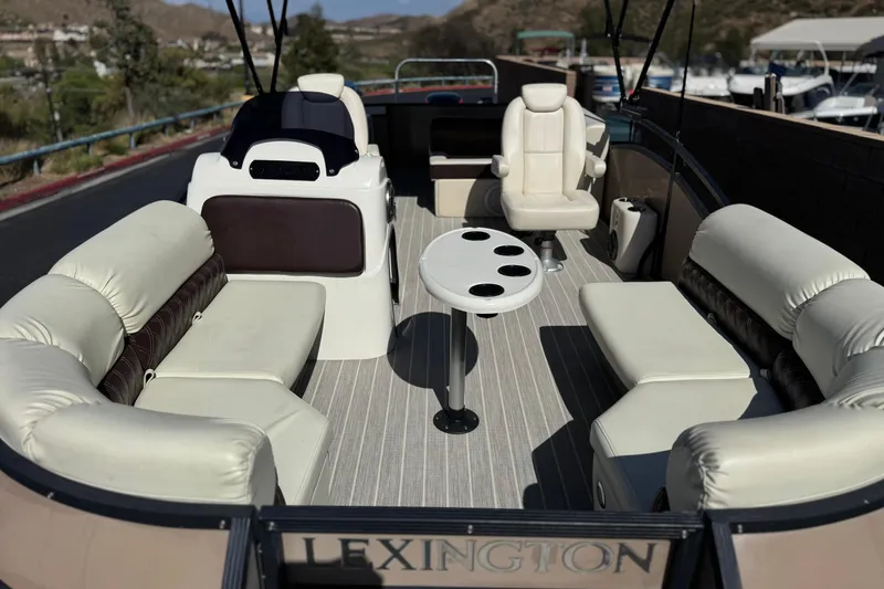 Slide: The Image of Luxurious 2023 Lexington 623 ST Xtreme pontoon boat interior with plush seating and cup holders. - 11