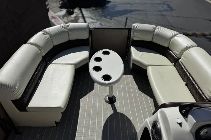 Slide: The Image of Luxurious seating area on 2023 Lexington 623 ST Xtreme boat with cupholder table. - 12