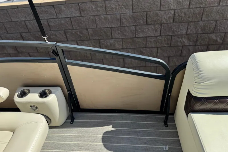 Slide: The Image of Interior of 2023 Lexington 623 ST Xtreme boat with beige seating and cup holders. - 15