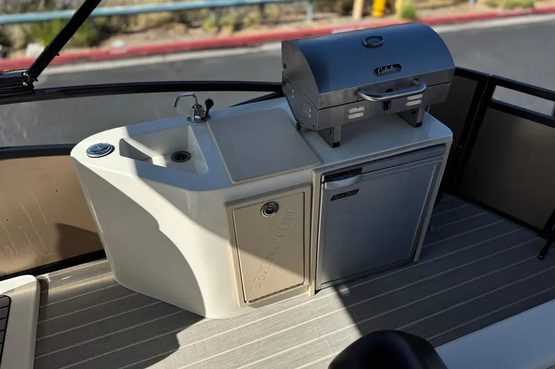 Slide: The Image of Outdoor kitchen setup on 2023 Lexington 623 ST Xtreme boat with grill and sink. - 18