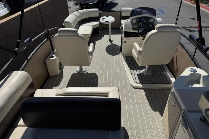 Slide: The Image of 2023 Lexington 623 ST Xtreme boat interior with plush seating and modern helm. - 23