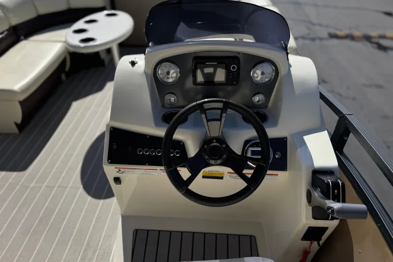 Slide: The Image of 2023 Lexington 623 ST Xtreme boat dashboard with steering wheel and controls. - 26