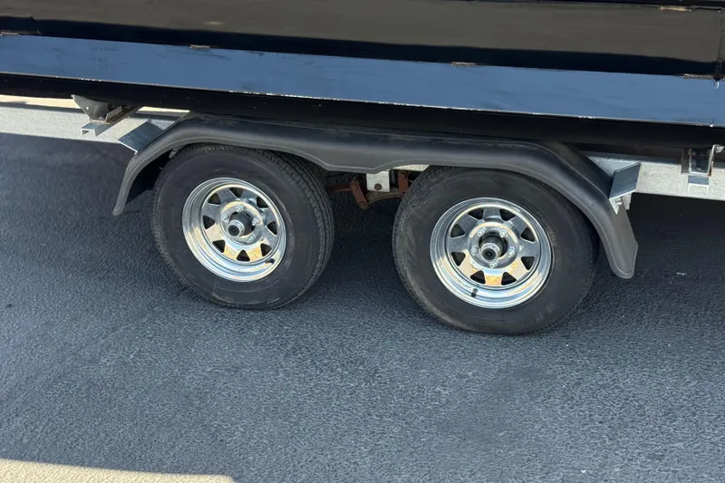 Slide: The Image of Dual wheels of a 2023 Lexington 623 ST Xtreme trailer on asphalt surface. - 29
