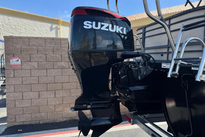 Slide: The Image of Outboard motor on a 2023 Lexington 623 ST Xtreme boat, featuring Suzuki branding. - 7