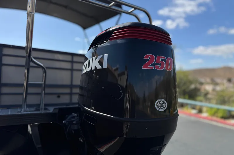 Slide: The Image of Outboard motor on 2023 Lexington 623 ST Xtreme boat under clear sky. - 8