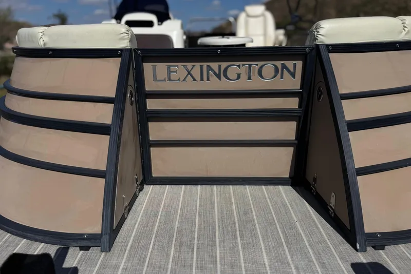 Slide: The Image of 2023 Lexington 623 ST Xtreme boat deck with beige seating and logo. - 9