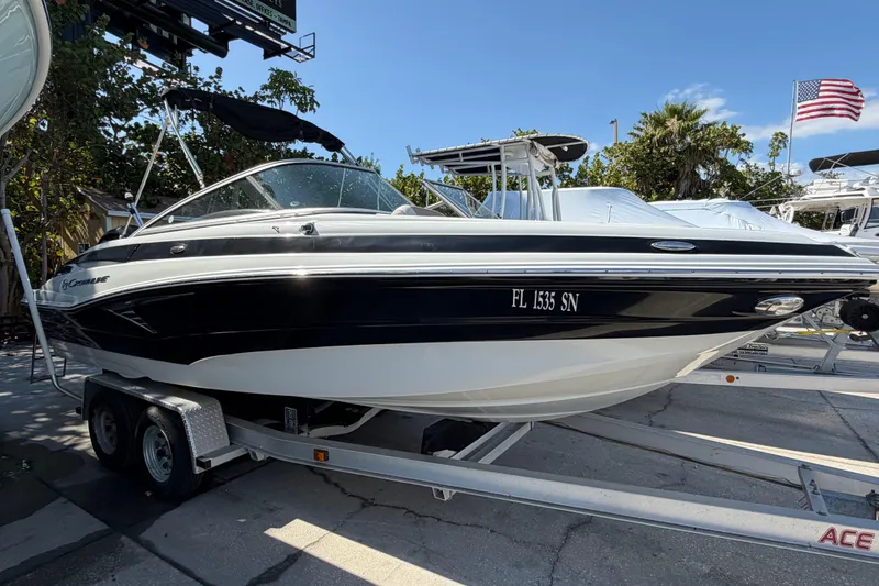 Slide: The Image of 2019 Crownline Eclipse E215 XS boat on trailer, parked outdoors. - 3