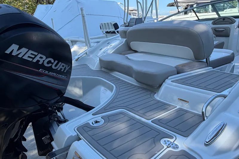 Slide: The Image of 2019 Crownline Eclipse E215 XS boat with Mercury FourStroke engine, featuring spacious seating and deck. - 4