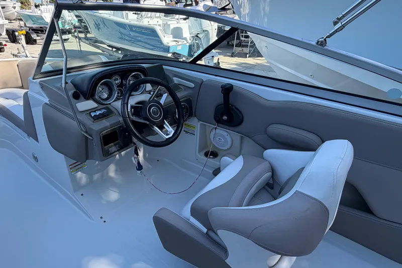 Slide: The Image of 2019 Crownline Eclipse E215 XS boat interior with steering wheel and seating. - 6