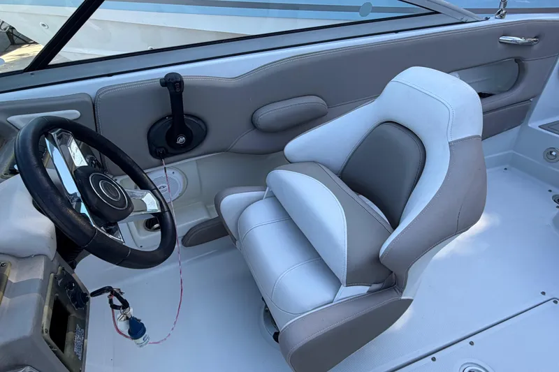 Slide: The Image of 2019 Crownline Eclipse E215 XS boat interior with steering wheel and captain's seat. - 7