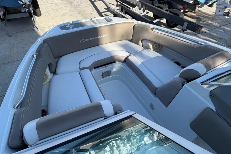 Slide: The Image of 2019 Crownline Eclipse E215 XS boat interior with gray seating and spacious layout. - 9