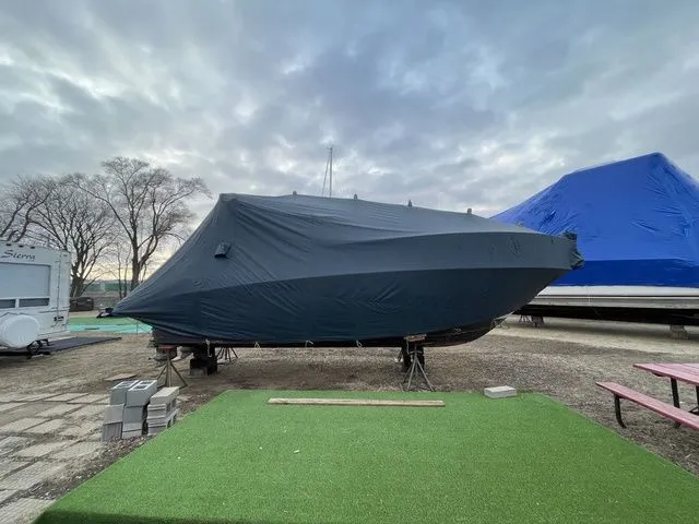 Slide: The Image of 2006 Cruisers Yachts 280CXI Express Cruiser covered at a boat storage yard. - 49