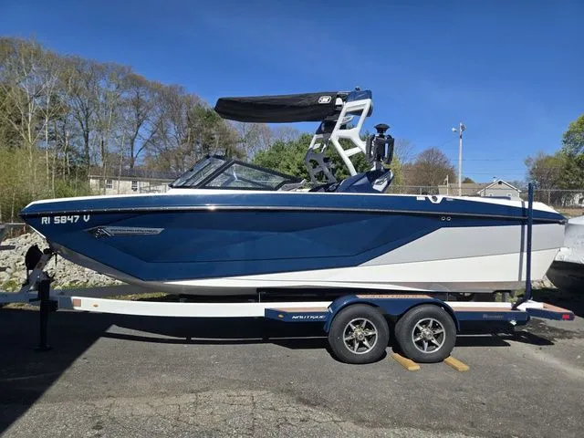 Slide: The Image of 2021 Nautique Super Air Nautique G23 on trailer, blue and white design. - 20