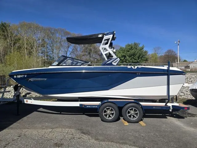 Slide: The Image of 2021 Nautique Super Air Nautique G23 on trailer, blue and white design. - 3