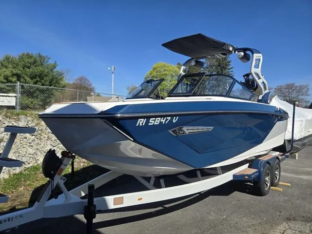 Slide: The Image of 2021 Nautique Super Air Nautique G23 on trailer, blue and white design. - 6