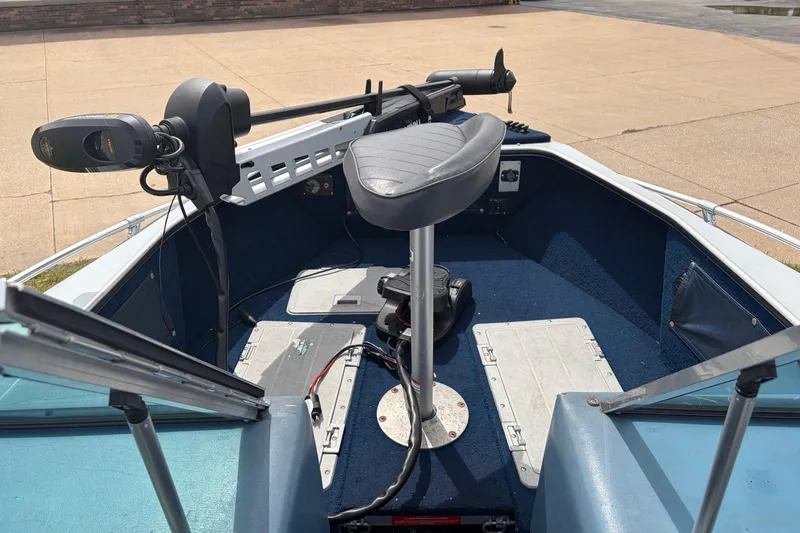 Slide: The Image of 1991 Lund 1750 Tyee boat interior with seating and trolling motor. - 12