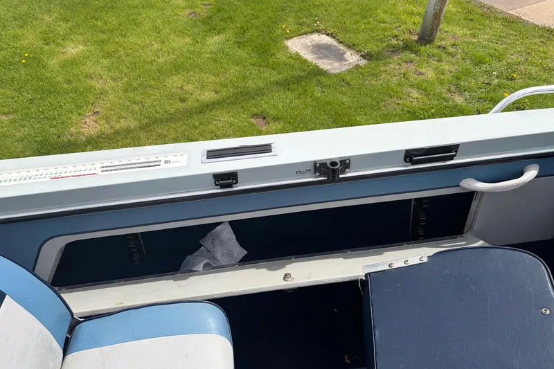 Slide: The Image of Interior view of a 1991 Lund 1750 Tyee boat with seating and storage. - 14