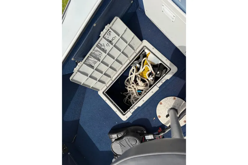 Slide: The Image of Open storage compartment with ropes on a 1991 Lund 1750 Tyee boat. - 16