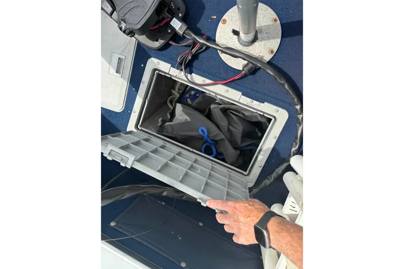 Slide: The Image of Open storage compartment on 1991 Lund 1750 Tyee boat with visible cables and equipment. - 17