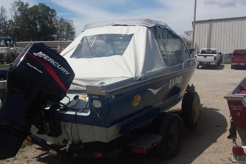 Slide: The Image of 1991 Lund 1750 Tyee boat with Mercury FourStroke engine on trailer. - 2
