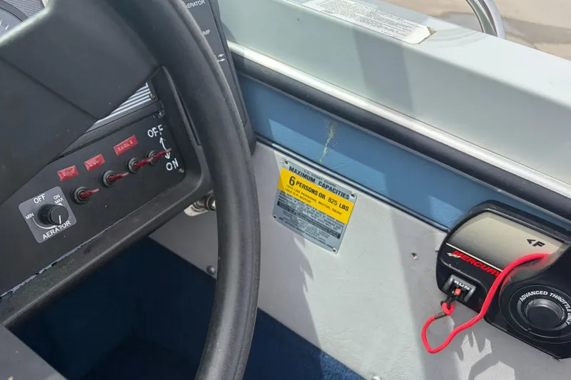 Slide: The Image of 1991 Lund 1750 Tyee boat dashboard with controls and capacity label. - 5