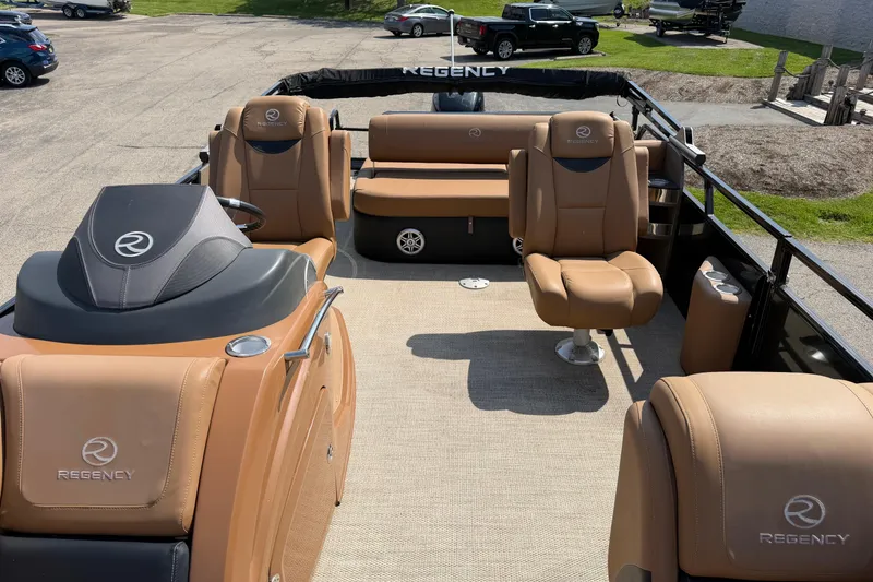 Slide: The Image of 2020 Regency 250 LE3 Sport boat interior with tan seating and steering console. - 13