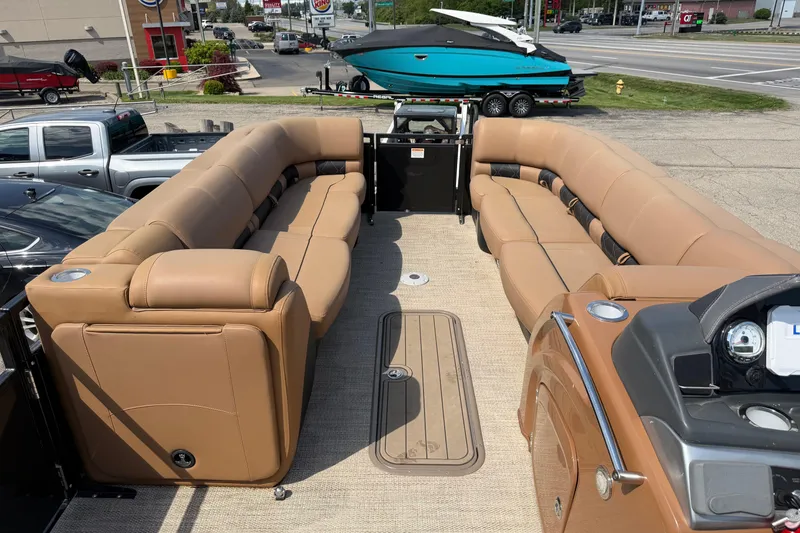 Slide: The Image of 2020 Regency 250 LE3 Sport pontoon boat with tan seating and modern dashboard. - 14