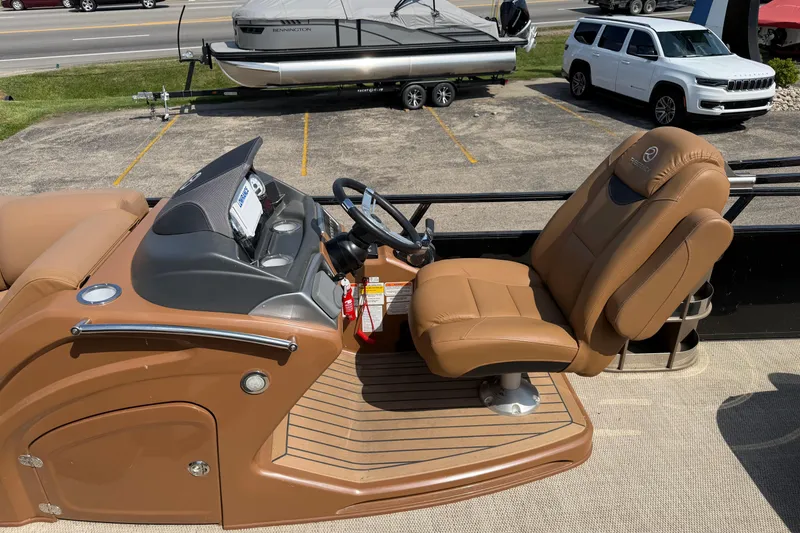 Slide: The Image of 2020 Regency 250 LE3 Sport boat interior with tan captain's chair and dashboard. - 18