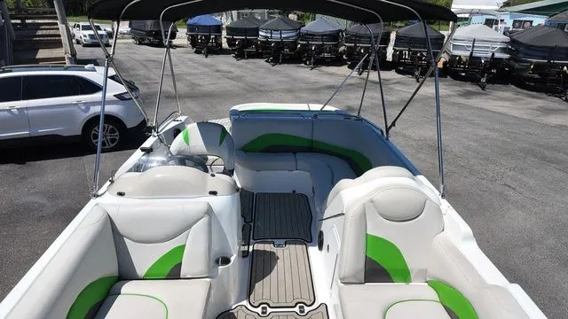 Slide: The Image of Interior view of a 2019 Hurricane SS 202 I/O boat with green accents. - 19