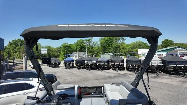 Slide: The Image of 2023 Sea-Doo Switch Sport 21 with canopy on parking lot. - 22
