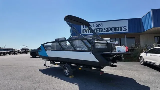 Slide: The Image of 2023 Sea-Doo Switch Sport 21 parked outside a powersports store. - 3