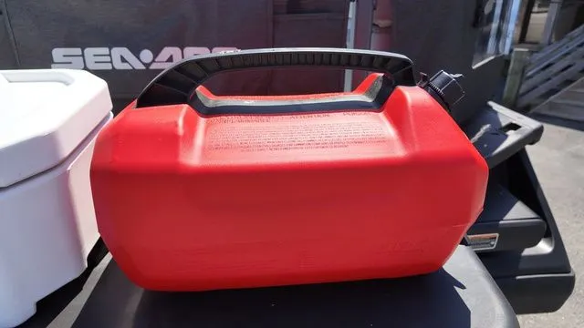 Slide: The Image of Red fuel canister beside 2023 Sea-Doo Switch Sport 21. - 7