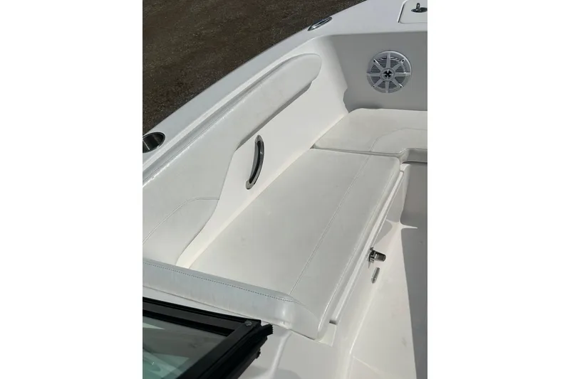 Slide: The Image of 2024 Aquasport 2200 Dual Console boat interior with white seating and speaker. - 12