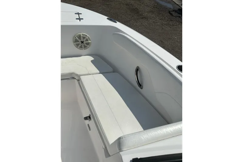 Slide: The Image of 2024 Aquasport 2200 Dual Console boat interior with white seating and speaker. - 13