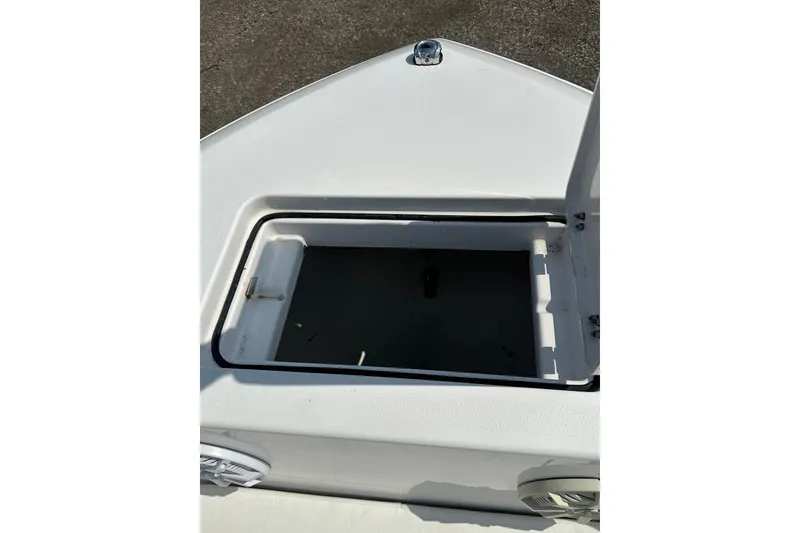 Slide: The Image of Open storage compartment on 2024 Aquasport 2200 Dual Console boat. - 14
