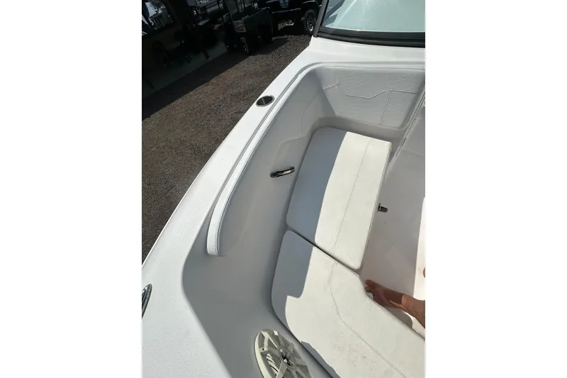 Slide: The Image of 2024 Aquasport 2200 Dual Console boat interior with white seating and speaker. - 15